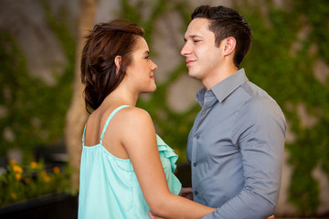 Obraz premium Good looking Hispanic couple looking at each other on a terrace