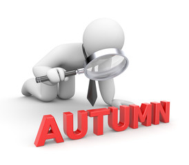Businessman examines something word Autumn