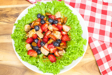 Berry salad with chicken, almond and lettuce.