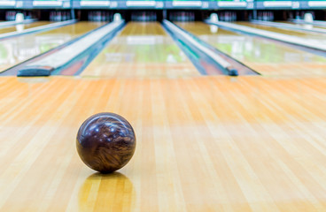 Brown bowling ball with Bowling alley.