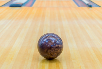Brown bowling ball with Bowling alley.