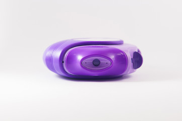 Purple powder asthma inhaler on white background