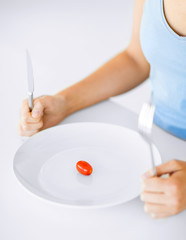 woman with plate and one tomato