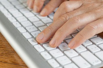 Male hands typing on the computer keyboard