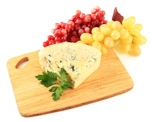 Tasty blue cheese and grape on cutting board, isolated on white