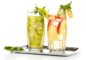 Glasses of fruit drinks with ice cubes isolated on white
