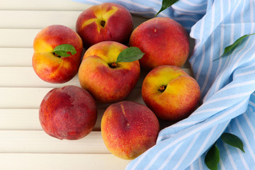 Peaches on napkin on wooden table