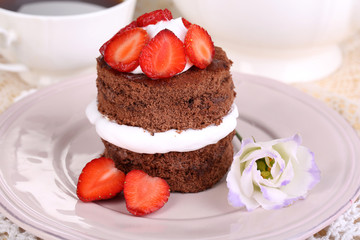 Chocolate cake with strawberry on table close-up