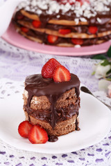 Chocolate cake with strawberry on wooden table close-up