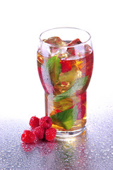Iced tea with raspberries and mint isolated on white