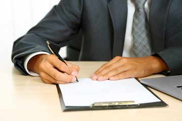 Closeup of businessman hands with clipboard