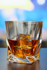 Glass of whiskey, on bright background