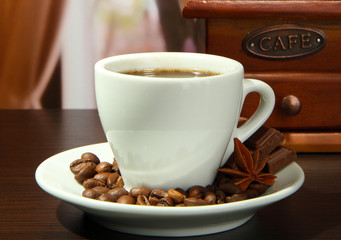 cup of coffee, grinder and coffee beans in cafe