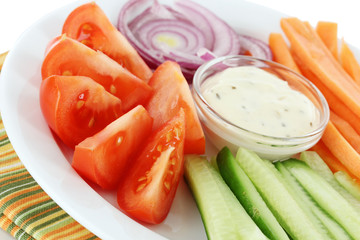 Assorted raw vegetables sticks in plate close up