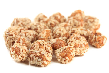 Tasty peanuts with sesame and caramel, isolated on white