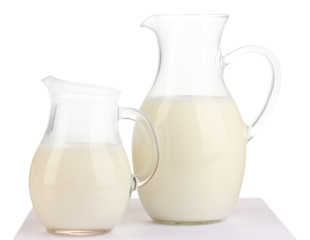 Milk in jugs isolated on white
