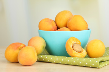 Fresh natural apricot in bowl on table in kitchen
