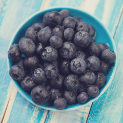 Ripe blueberries in a saucer, view from above