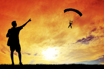 Obraz na płótnie Canvas Paragliding silhouette at sunset