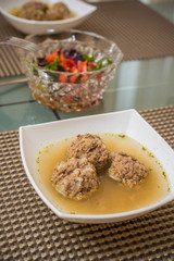 Plate of soup with meatballs