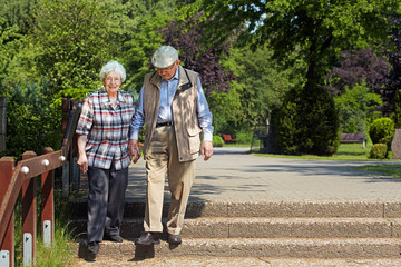 aged couple coming down the stairs