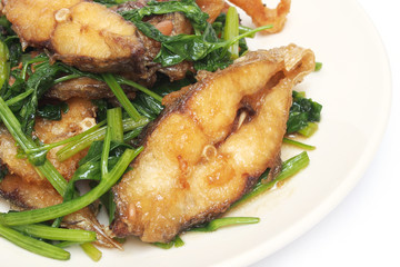 Fried crisp fish with coriander on plate