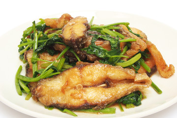 Fried crisp fish with coriander on plate
