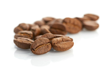 Macro of coffee beans isolated on white background