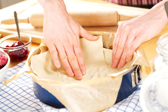 Female hands kneading dough in a pie form