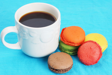 Coffee and macarons on blue