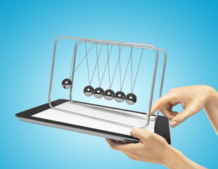 newton's cradle and tablet