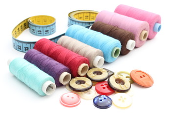 Colorful spools of thread, tape measure and buttons