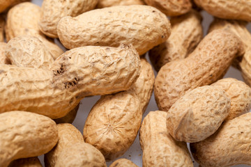 .Dried peanuts in closeup on the white background
