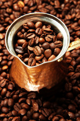 Metal turk on coffee beans background