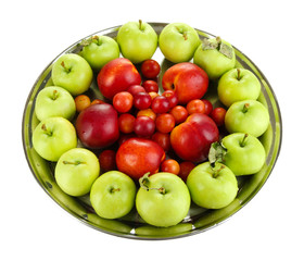 Assortment of juicy fruits on plate, isolated on white