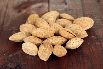 Almond on dark wooden background