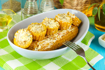 Flavored boiled corn on  plate on wooden table close-up