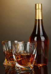 Glass of whiskey with bottle, on dark background