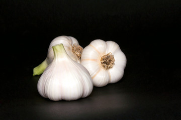 Garlic bulbs, on black background.