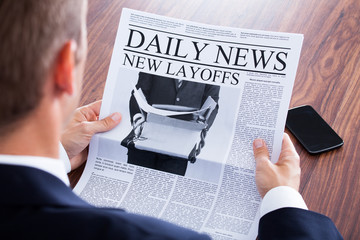 Close-up Of Businessman Reading News