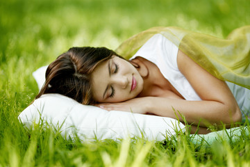 Woman sleeping on grass