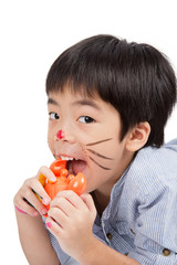 handsome asian boy eating a toy crab