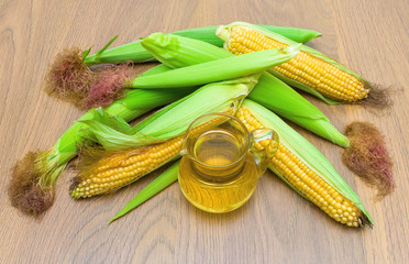 ears of corn and oil. top view - horizontal photo.