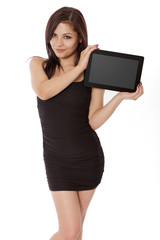 Pretty woman in a little black dress holds a blank tablet comput