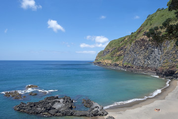 People sunbathing at the beach of an island