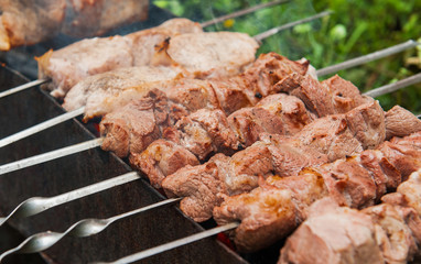 shashlik at nature.Process of cooking meat on barbecue, closeup.