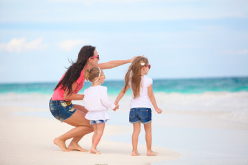 Young mother and her cute daughters enjoy summer vacation at