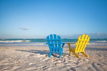 Beach wooden colorful chairs for vacations on tropical beach in