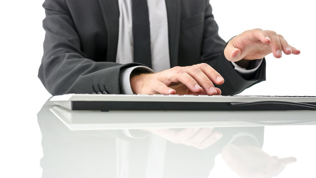 Typing on computer keyboard on white office desk