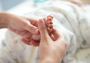 massaging little baby's foot